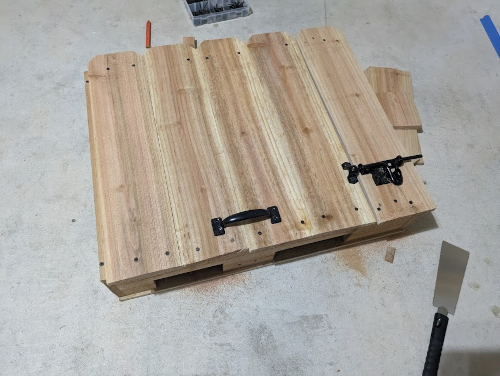 Box with a hinged lid and latch mounted to the outside