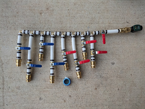 Pipe fittings and valves connected together on a concrete floor
